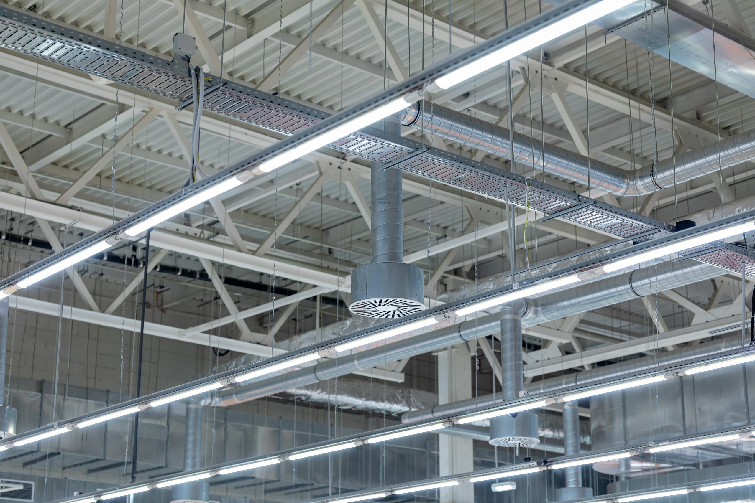 Ceiling air conditioning of the stadium or exhibition hall roof. Lamps with diode lighting and ventilation under the ceiling of a modern warehouse or shopping center. Selective Focus